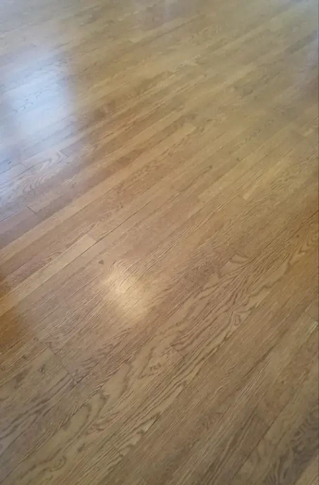 Close-up of a light wood floor with sunlight reflections