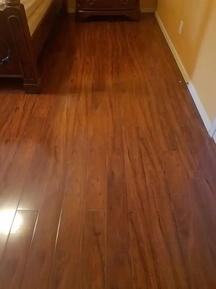 Empty wooden hallway with glossy floor and beige walls