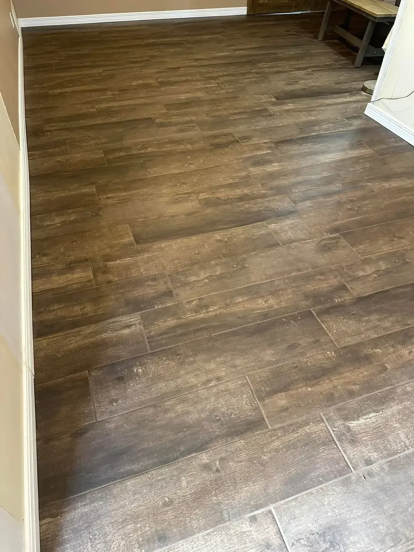 Empty hallway with dark wood flooring and white walls