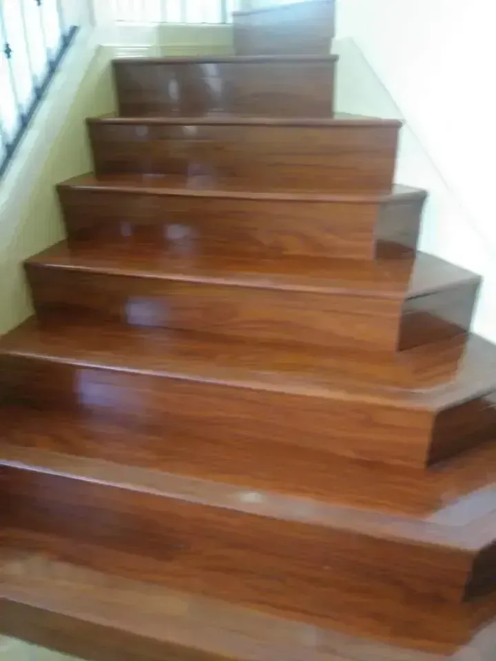 Wooden staircase with polished steps and white side walls