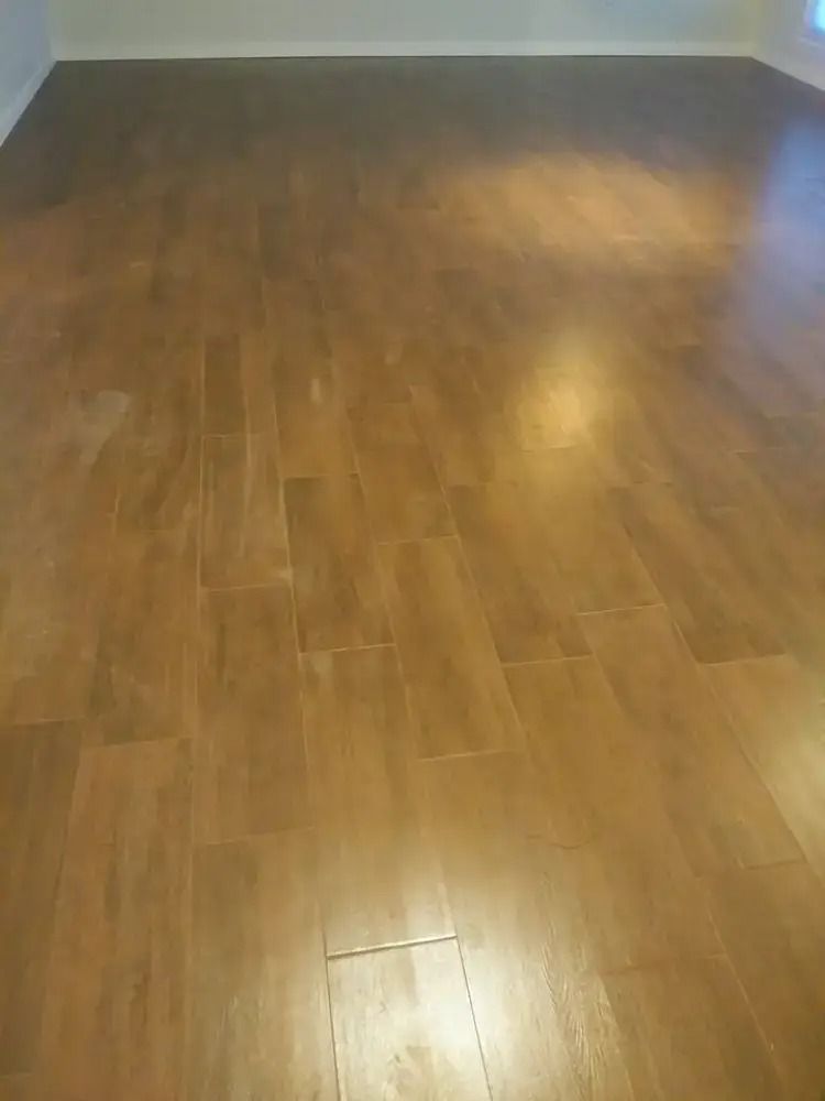 Empty room with glossy brown wood flooring and light-colored walls