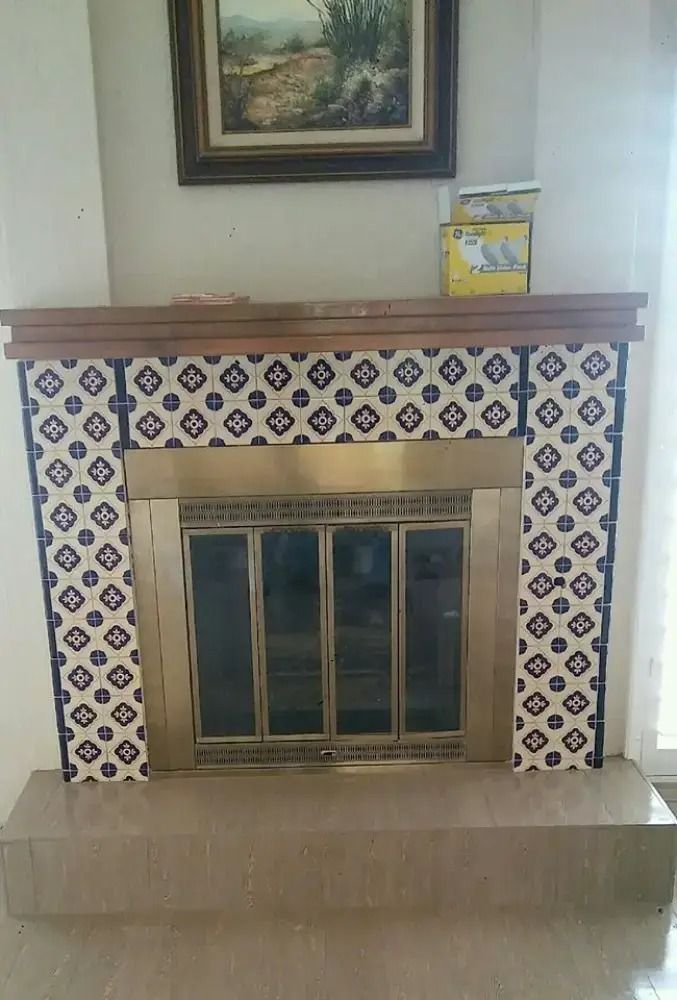Decorative fireplace with blue-and-white tile surround and a framed painting above it