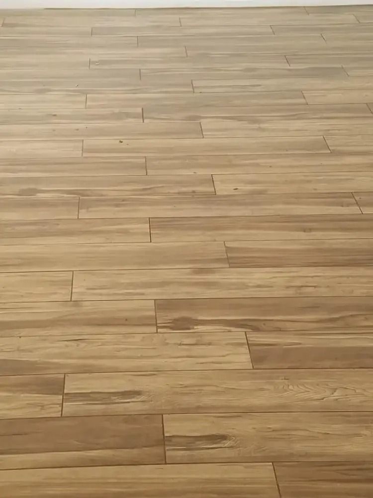 Light wood floor with horizontal plank seams and subtle grain patterns