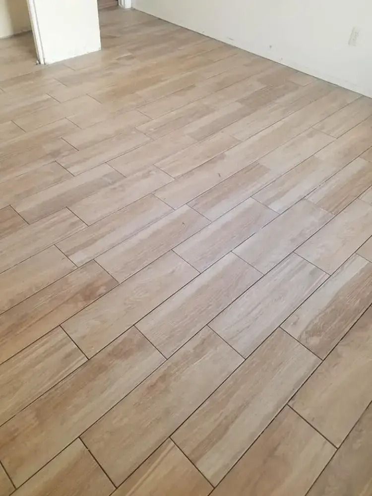 Empty room with light wood plank flooring and white walls