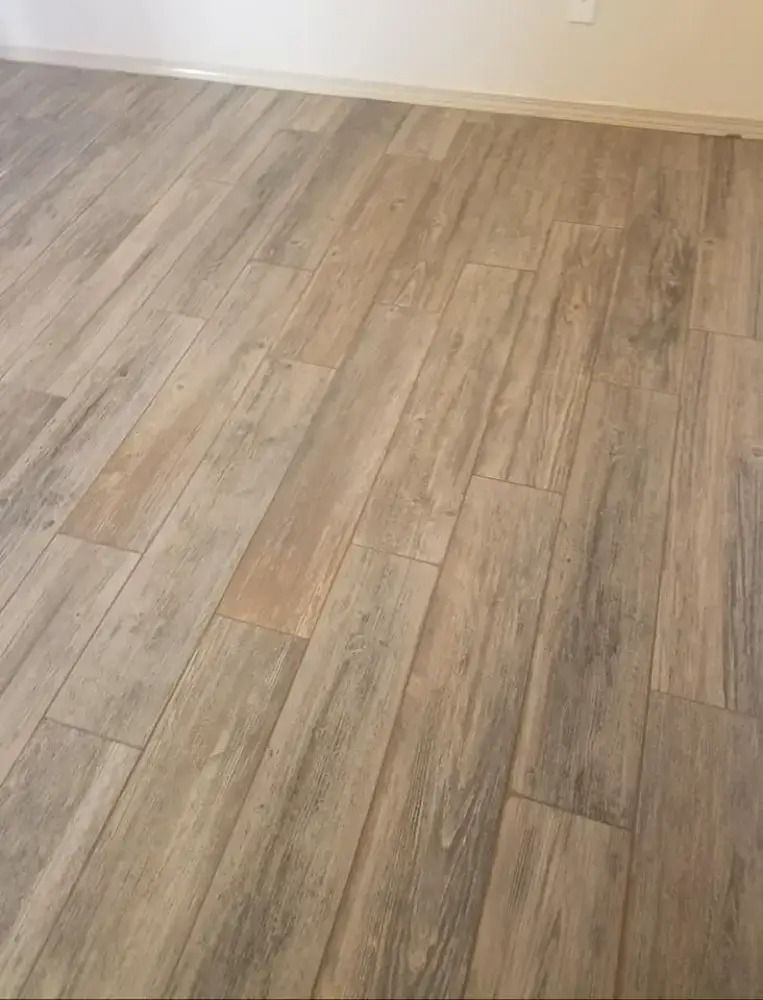Empty room with light wood flooring and beige walls