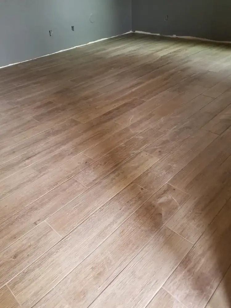 Empty room with light wood flooring and gray walls