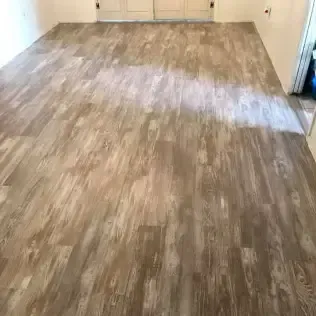 Empty room with light wood-look flooring and beige walls