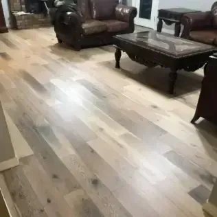 Living room with brown leather chairs, dark coffee table, and light wood floor