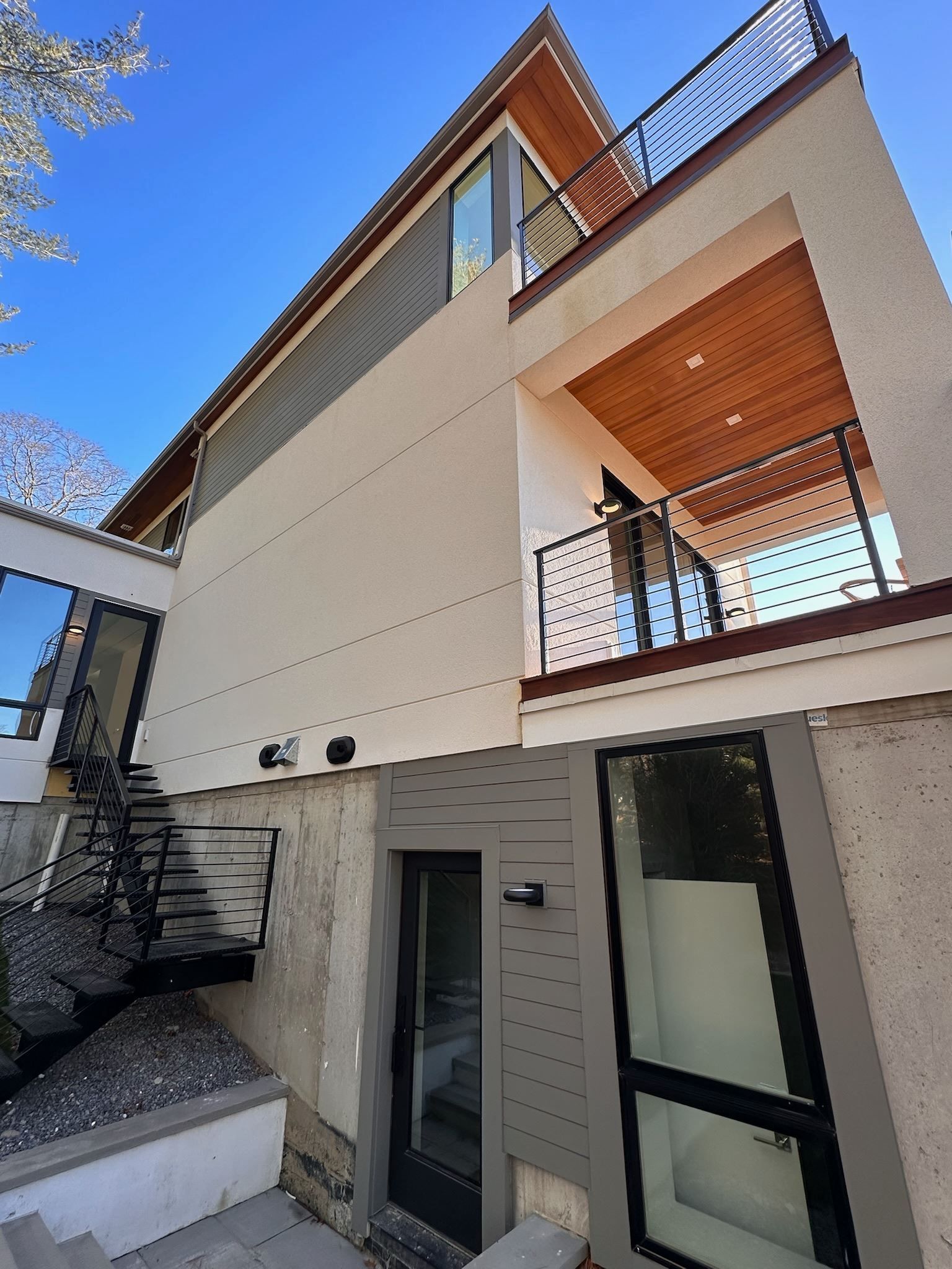 A white house with a balcony and stairs