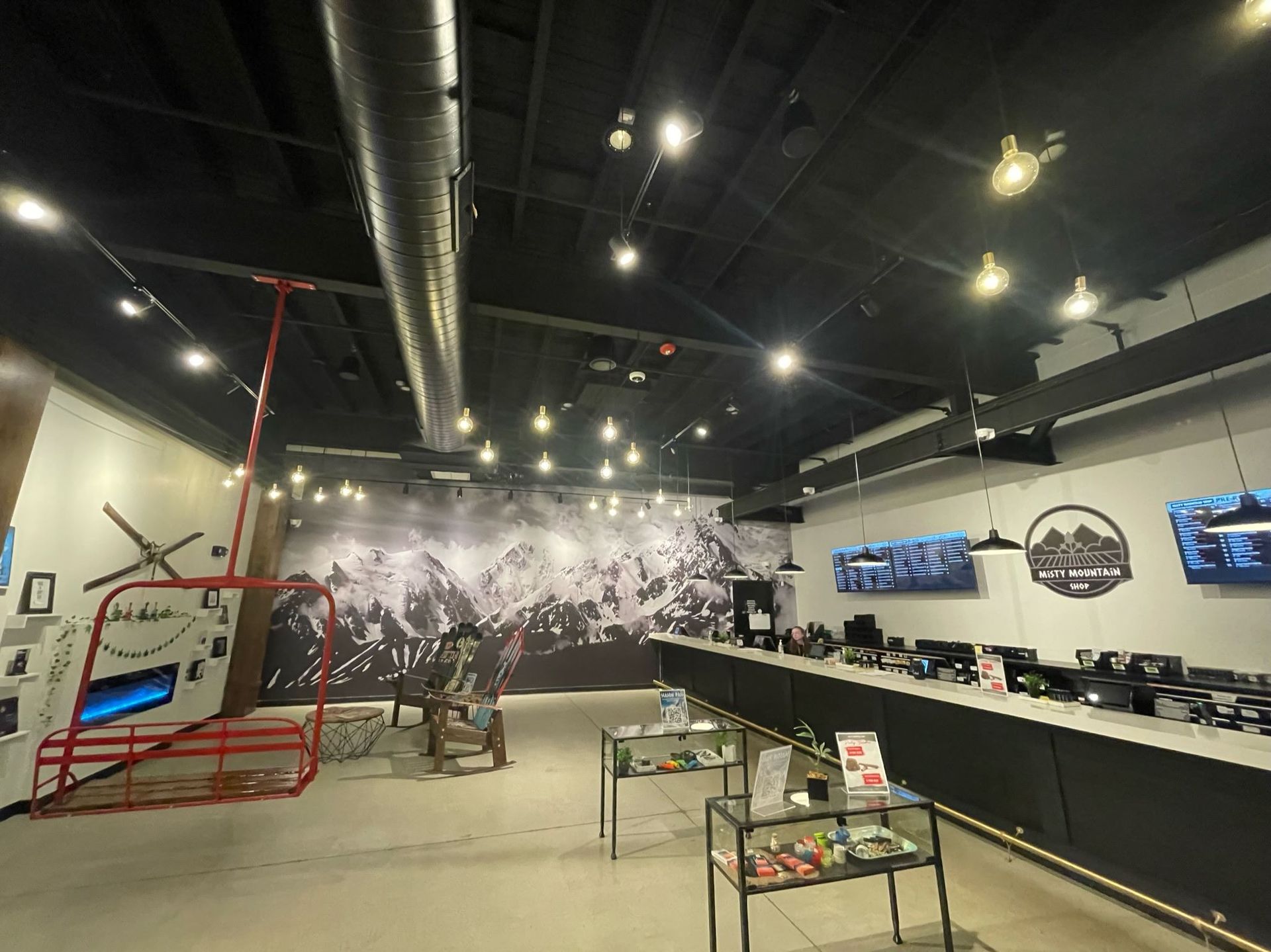 A large room with a lot of lights and a helicopter on the wall.