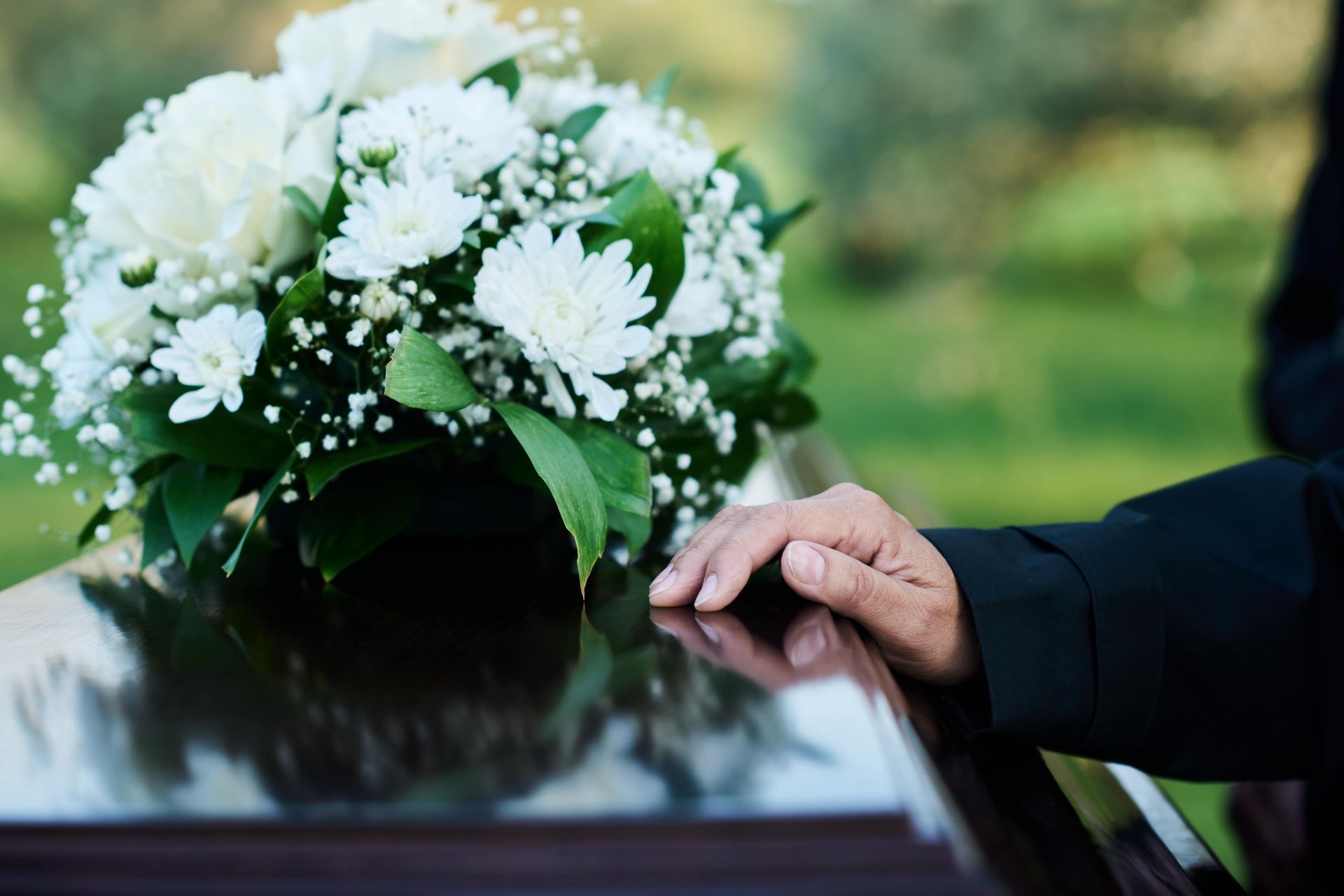 white floral tribute on top of coffin