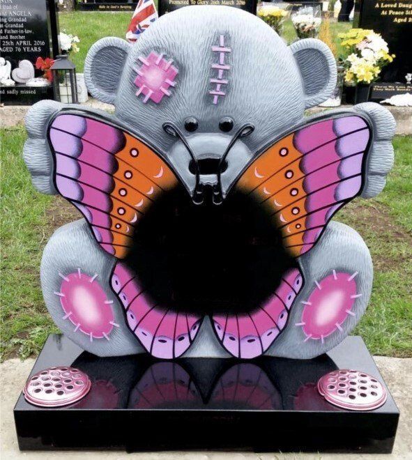 Bear holding a butterfly headstome