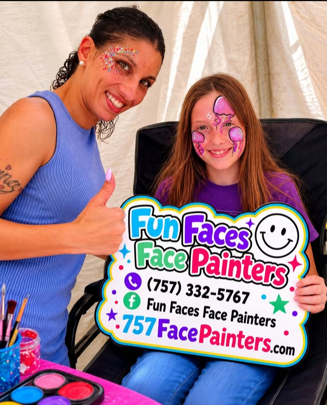 Two smiling face painters beside a sign reading “Fun Faces Face Painters” with a phone number and website.
