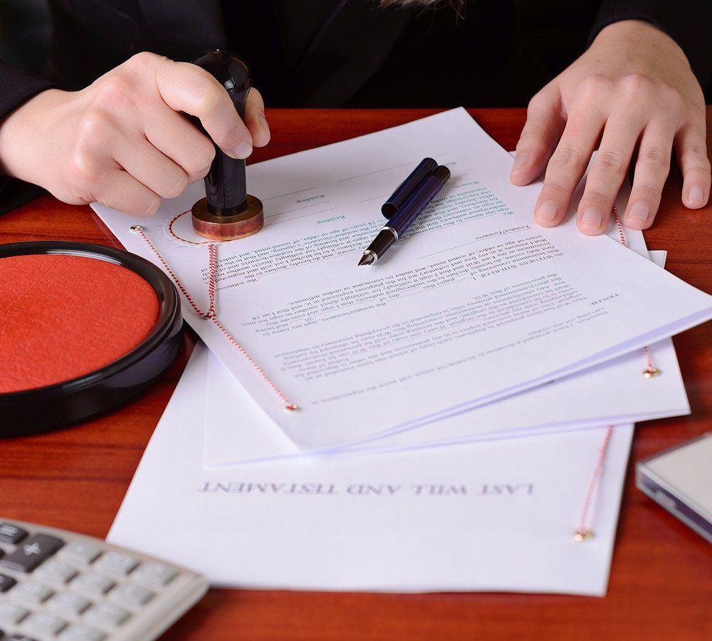 Notary's Public Hands Stamping the Testament and Last Will — Sanford, NC — Stephenson & Stephenson PA Attorneys at Law A probate lawyer filling out paperwork in Pittsboro, NC