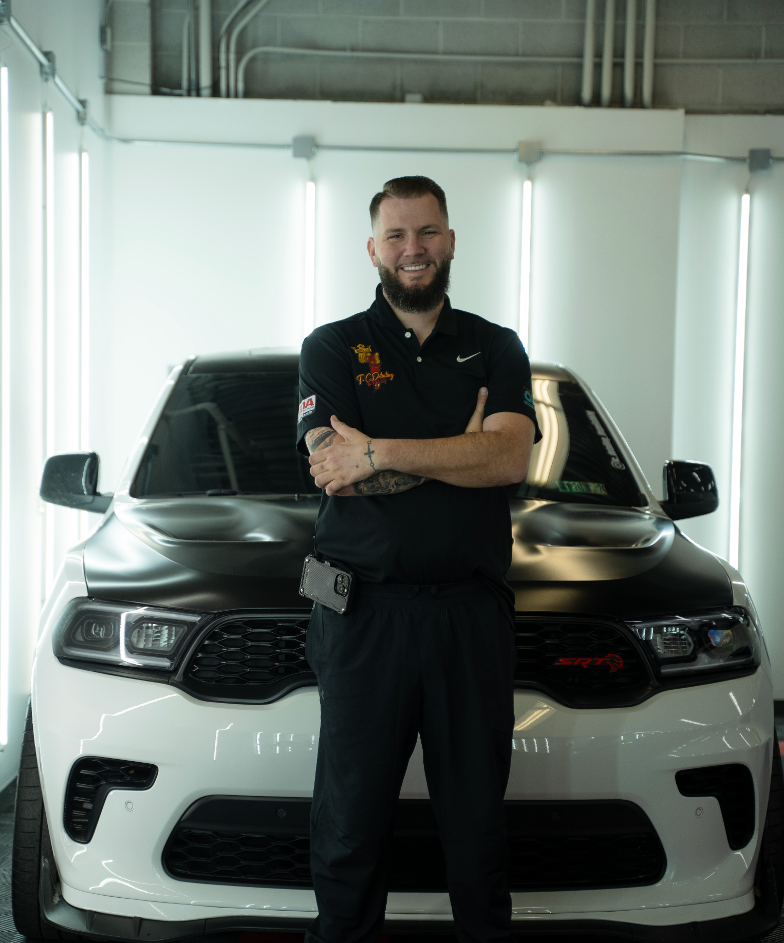 Red Lamborghini Huracan parked in a detailing shop on a checkered floor with Rupes branding.
