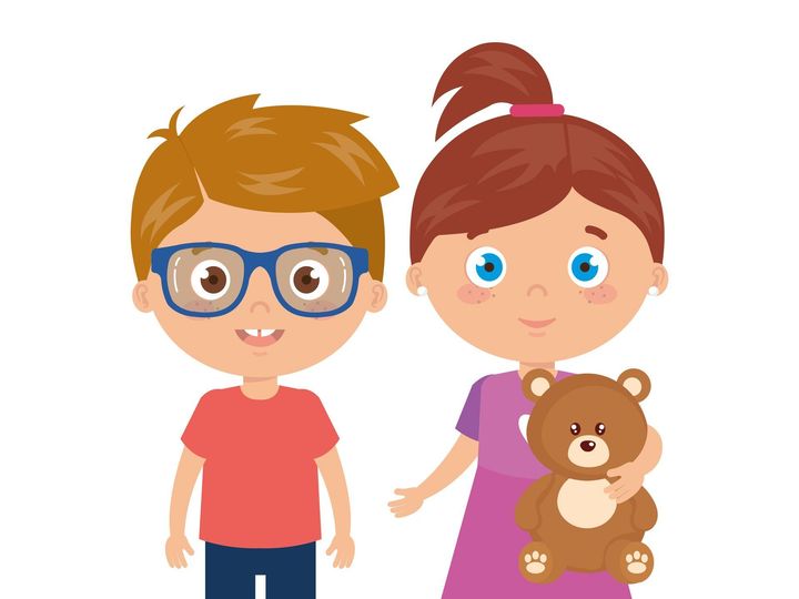A boy and a girl are standing next to each other holding a teddy bear.