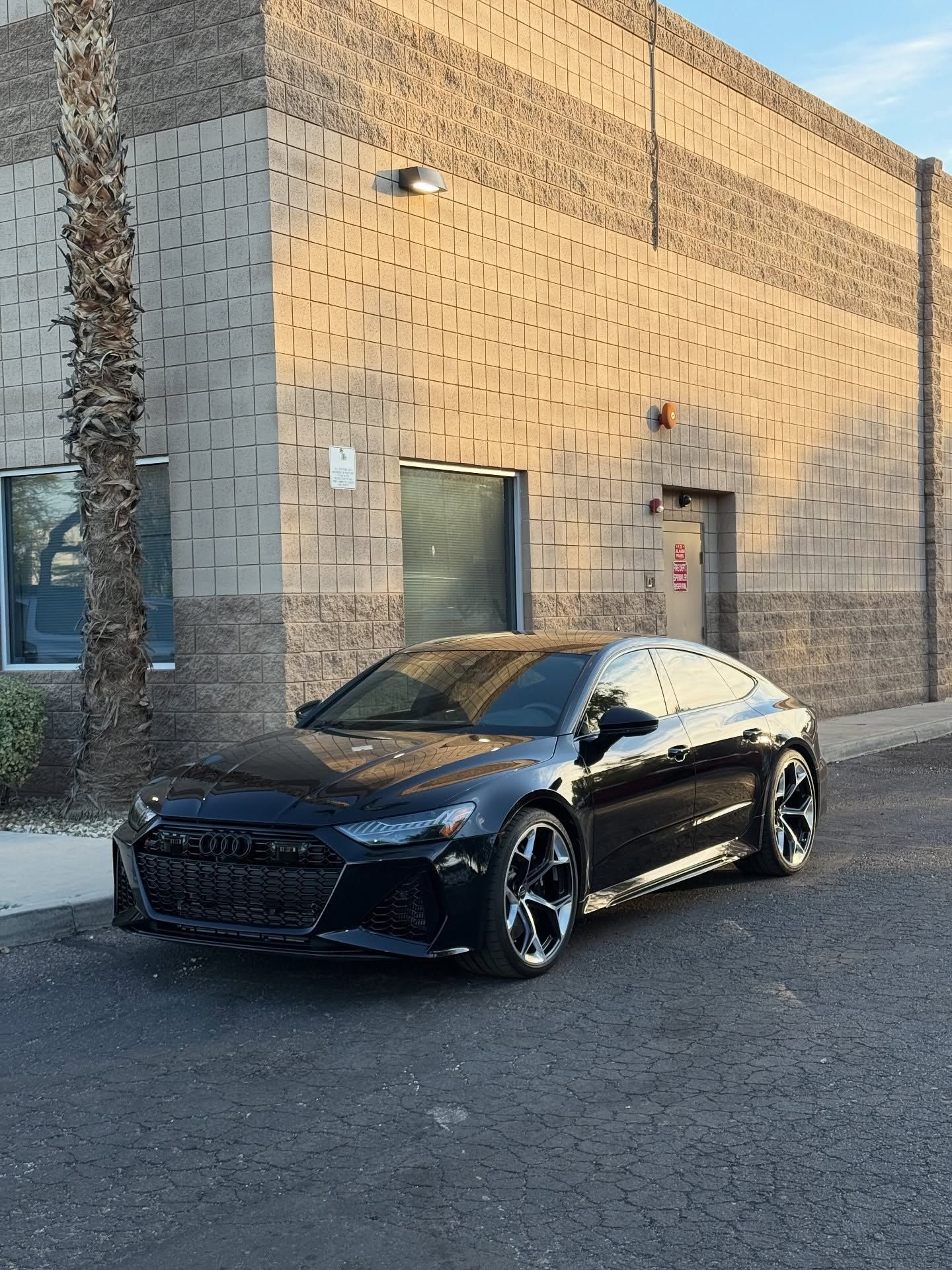 Black sedan with tinted windows at Impeccable Detail, a window tint shop in Phoenix, AZ