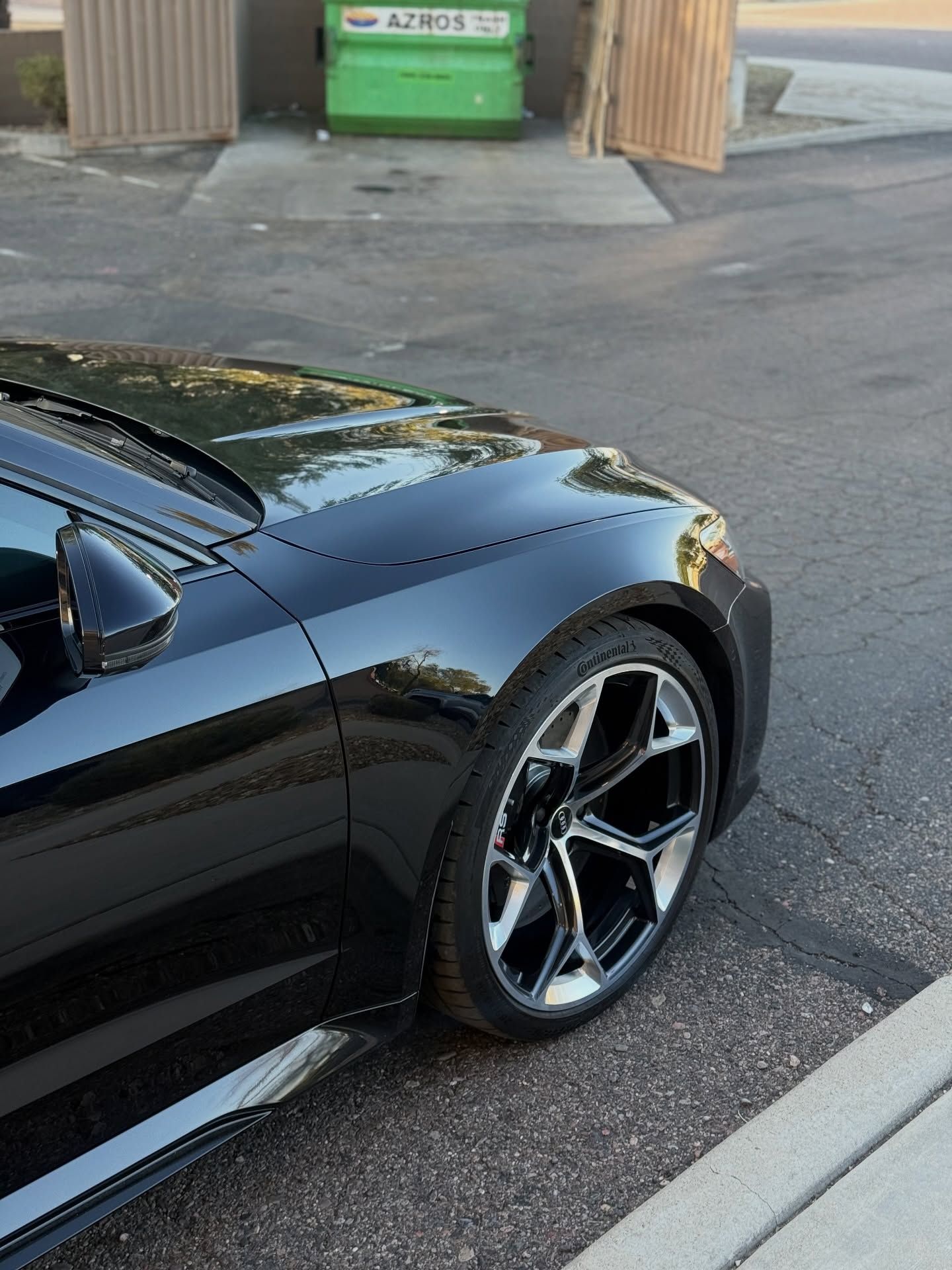 Glossy black car fender and wheel at Impeccable Detail in Phoenix, AZ