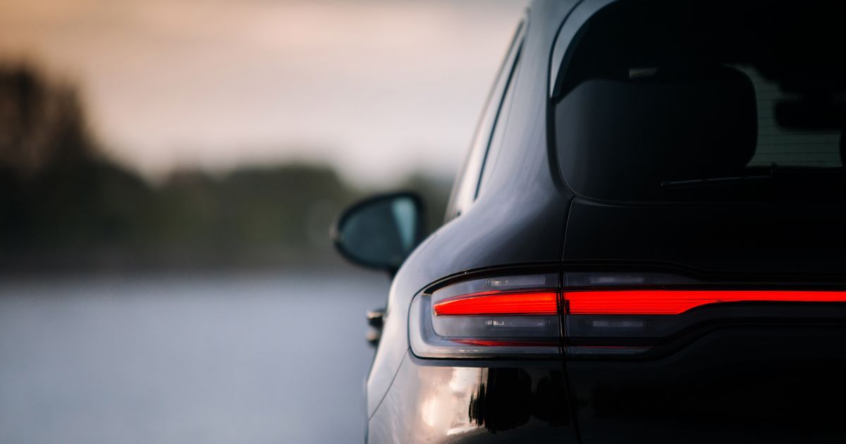 Rear light bar of a dark Porsche SUV, a paint protection film candidate in Phoenix