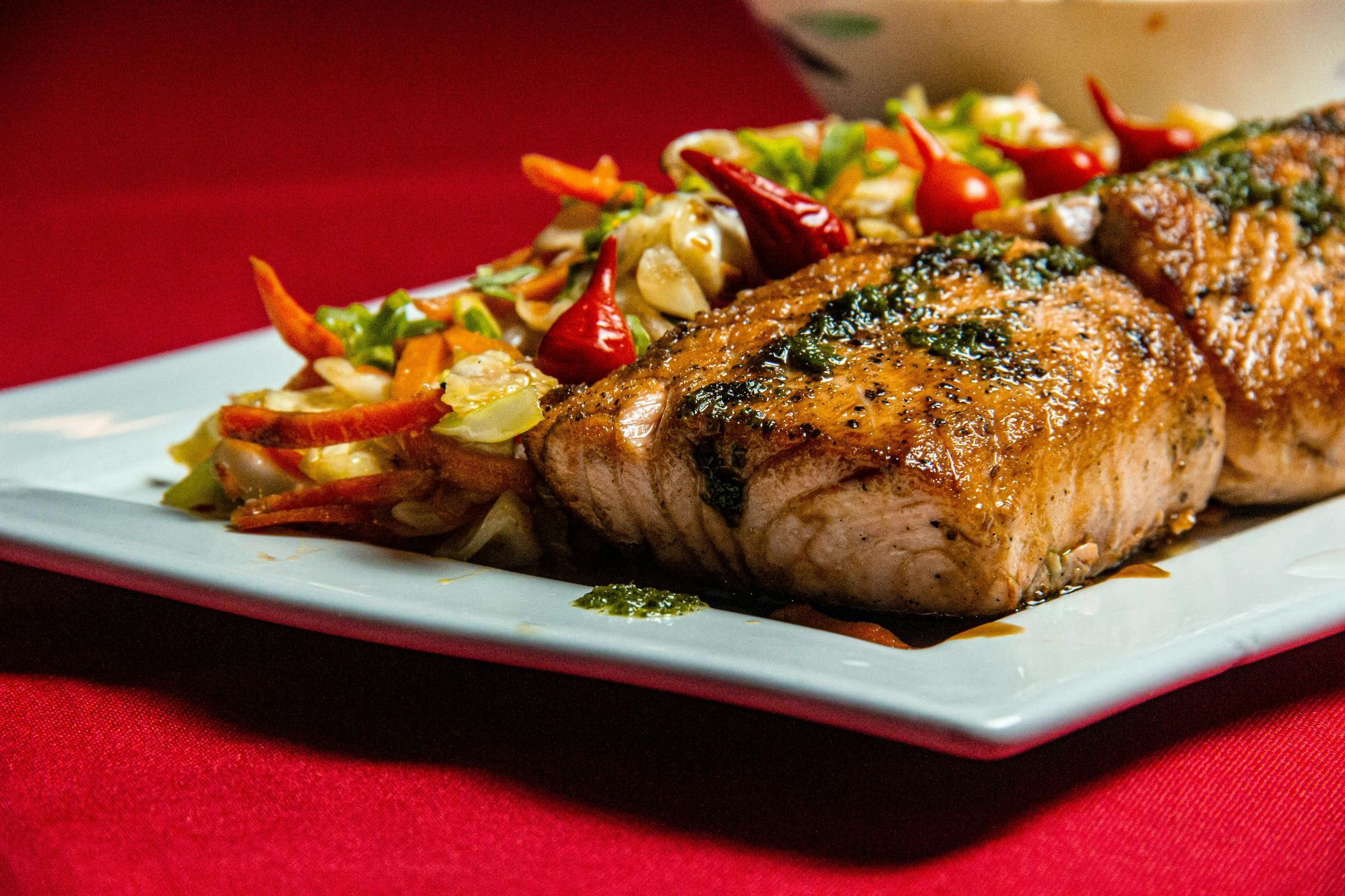 A plate of food with meat and vegetables on a table.