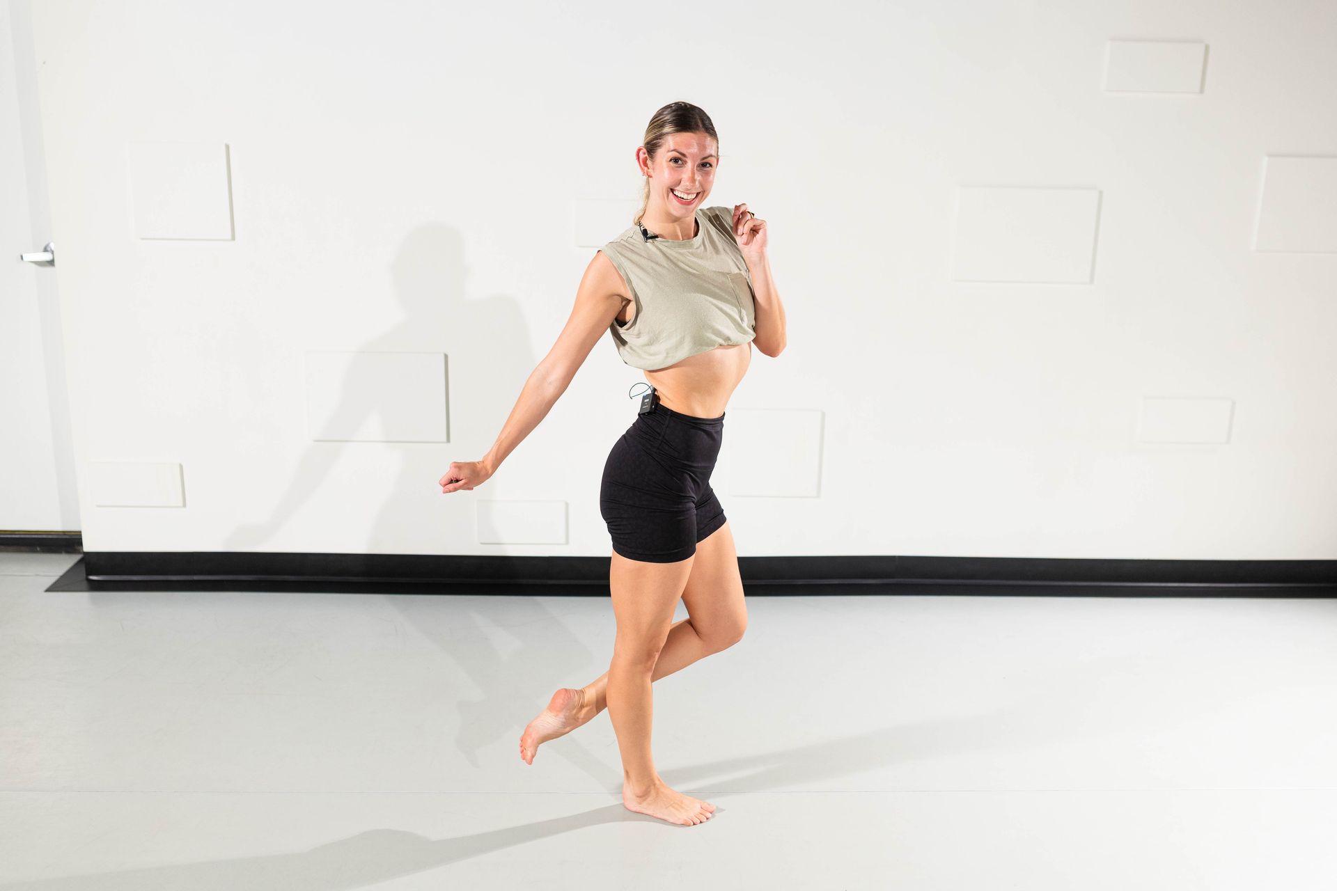 A group of women are dancing together in a fitness space.