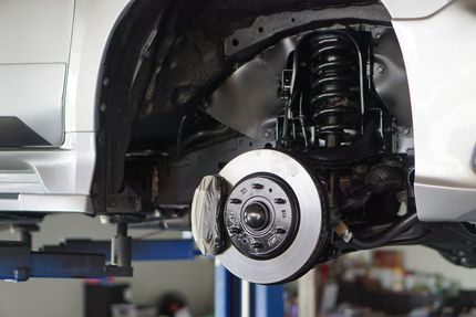 A Car is Being Repaired on a Lift in a Garage — Maroochy Automotive in Kunda Park, QLD