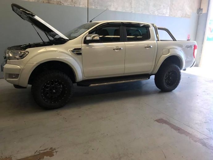 A white ute With the Hood Up is Parked in a mechanics workshop — Maroochy Automotive in Maroochydore, QLD