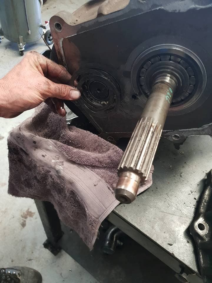 A Man Repairs a Gear Box in a Garage — Maroochy Automotive in Kunda Park, QLD