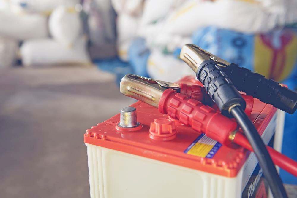 Car Battery With Red and Black Jumper Cable Clamps — Maroochy Automotive in Kunda Park, QLD