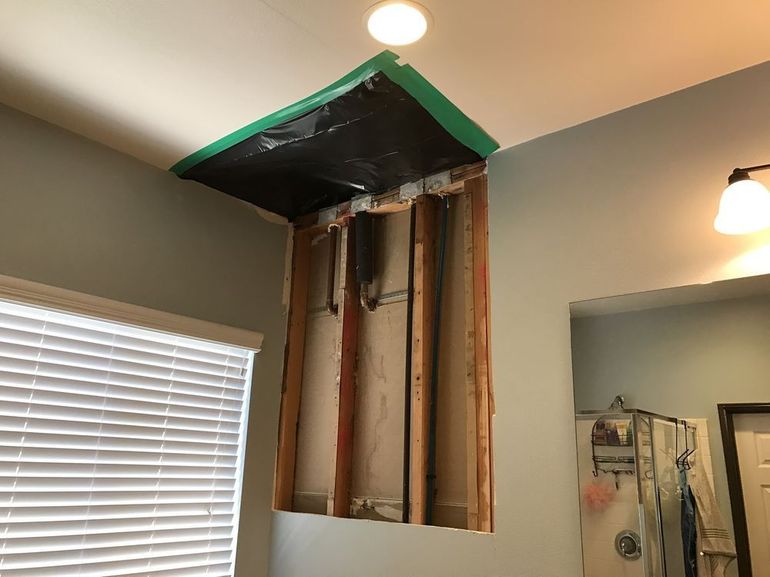 a bathroom with a wall that is being remodeled