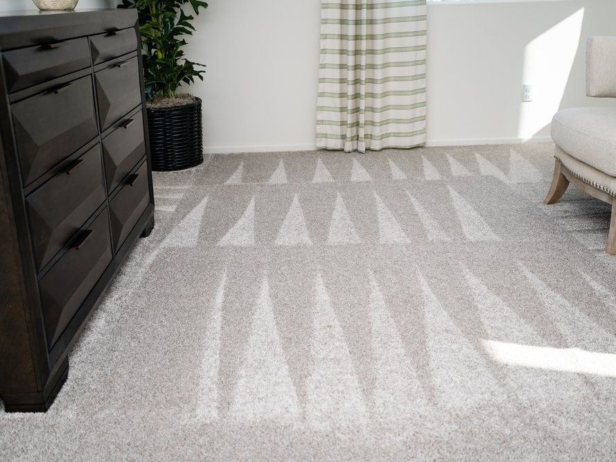 a living room with a rug and a dresser