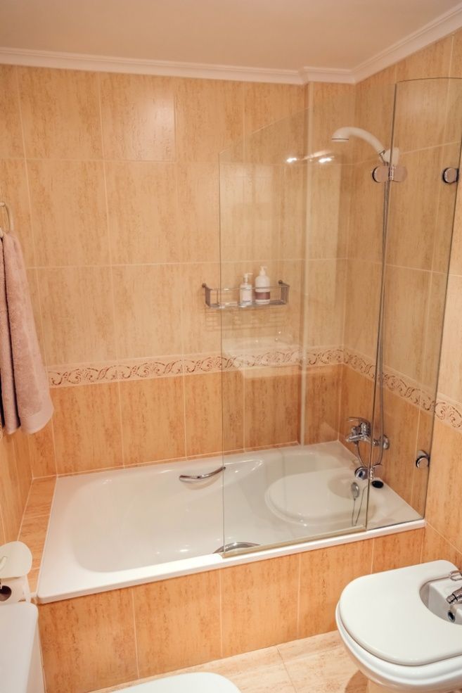A Bathroom With A Bathtub, Toilet And Shower — InStyle Shower Screens & Wardrobes in Maitland, NSW