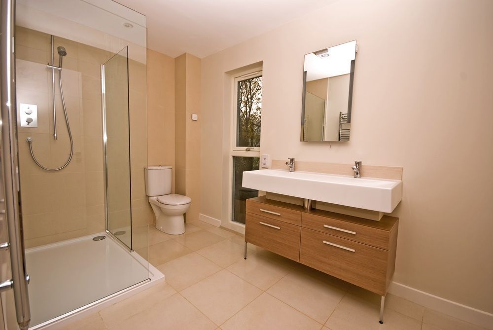 A Bathroom With A Toilet, Sink, Mirror And Walk In Shower — InStyle Shower Screens & Wardrobes in Newcastle, NSW