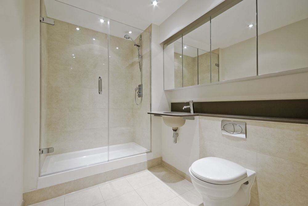 A Bathroom With A Toilet, Sink And Shower — InStyle Shower Screens & Wardrobes in Maitland, NSW