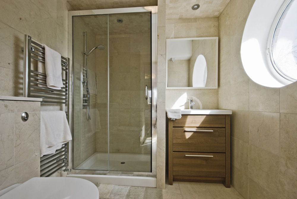 A Bathroom With A Toilet, A Sink And A Shower — InStyle Shower Screens & Wardrobes in Gosford, NSW