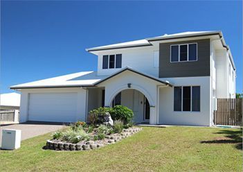 A Large White House with A Garage and A Lot of Windows — Leader Constructions in Cranbrook, QLD