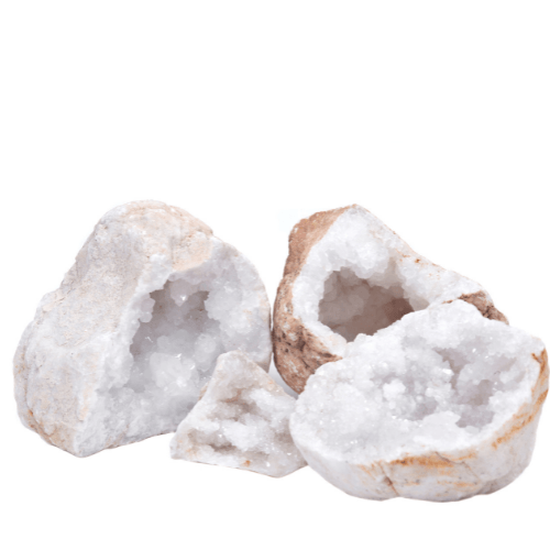 White quartz rock crystals with rough surfaces and tan edges, arranged on a white background