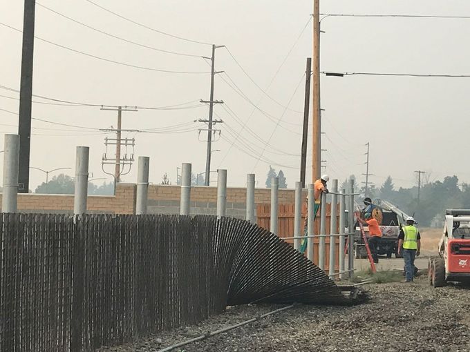 Your Expert Fencing Contractor A group of construction workers are working on a fence