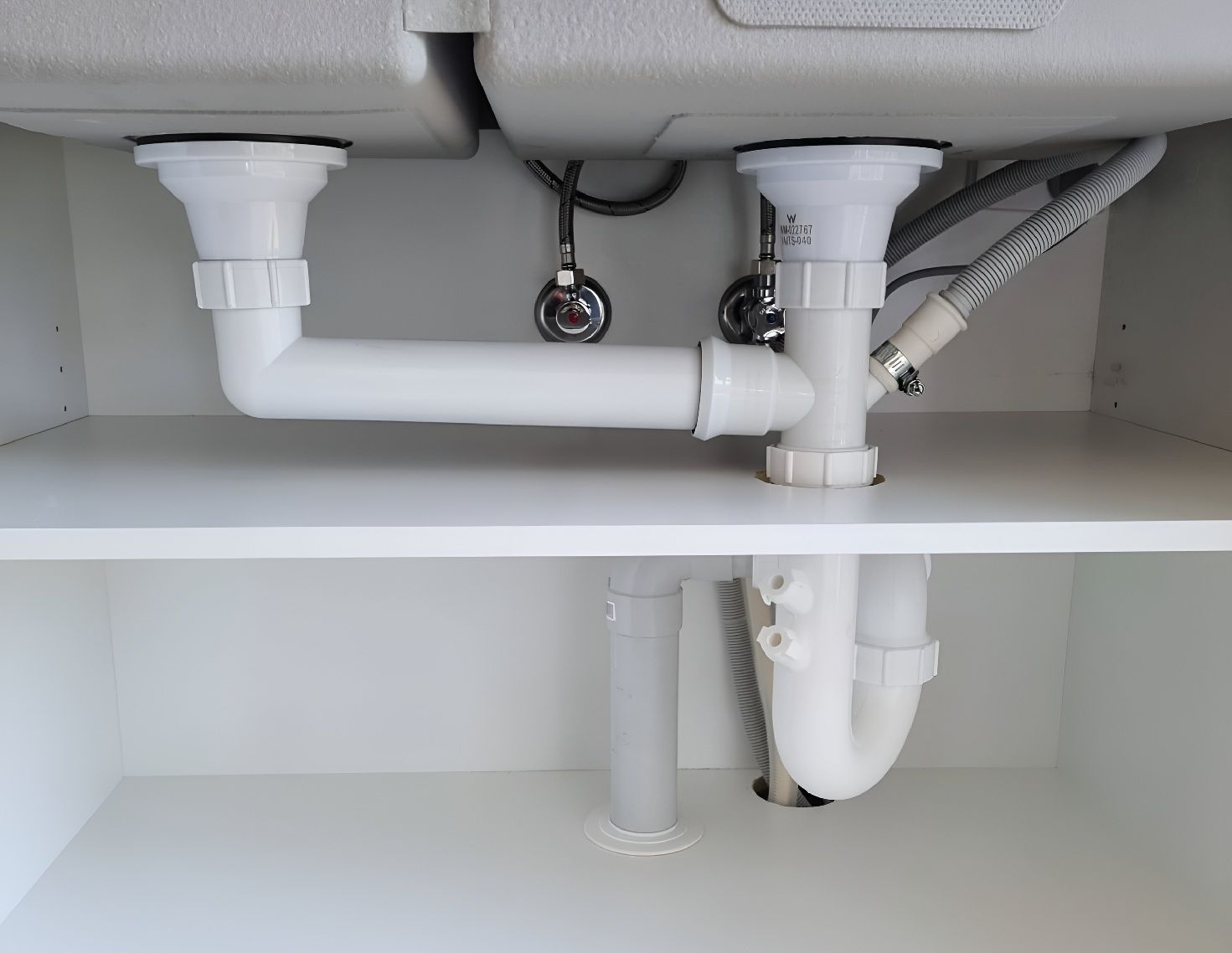 Under-Sink Plumbing Pipes Showing Typical Household Drainage System
