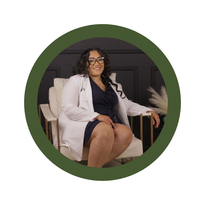 A woman in a lab coat is sitting in a chair.