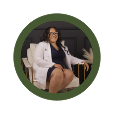 A woman in a lab coat is sitting in a chair.