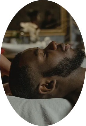 A man with a beard is laying down with his eyes closed