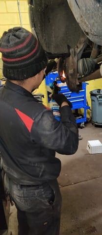 A car engine is being worked on in a garage.