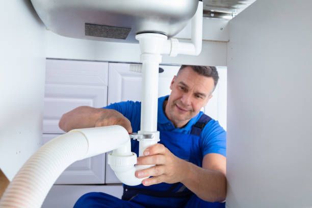 Person fixing a pipe.