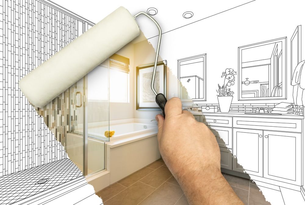 Hand using a paint roller over a sketched bathroom design, revealing the finished room with a bathtub.