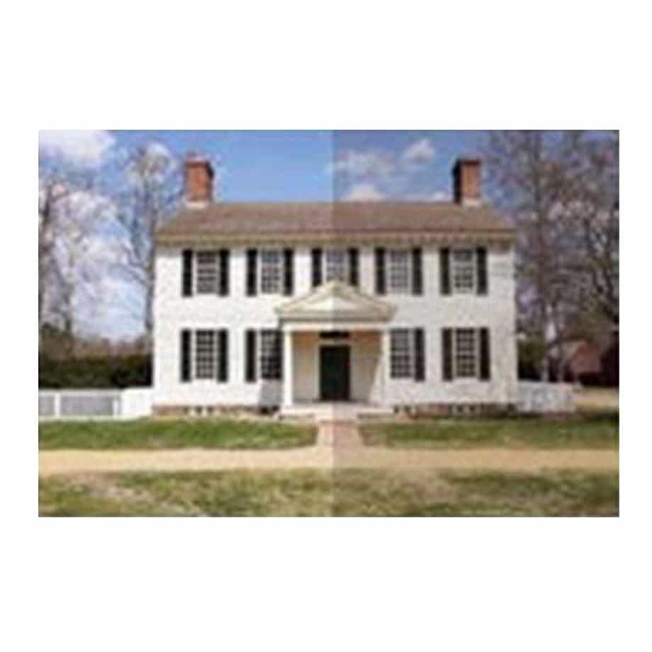 White colonial house with black shutters, red brick chimneys, and a small porch.