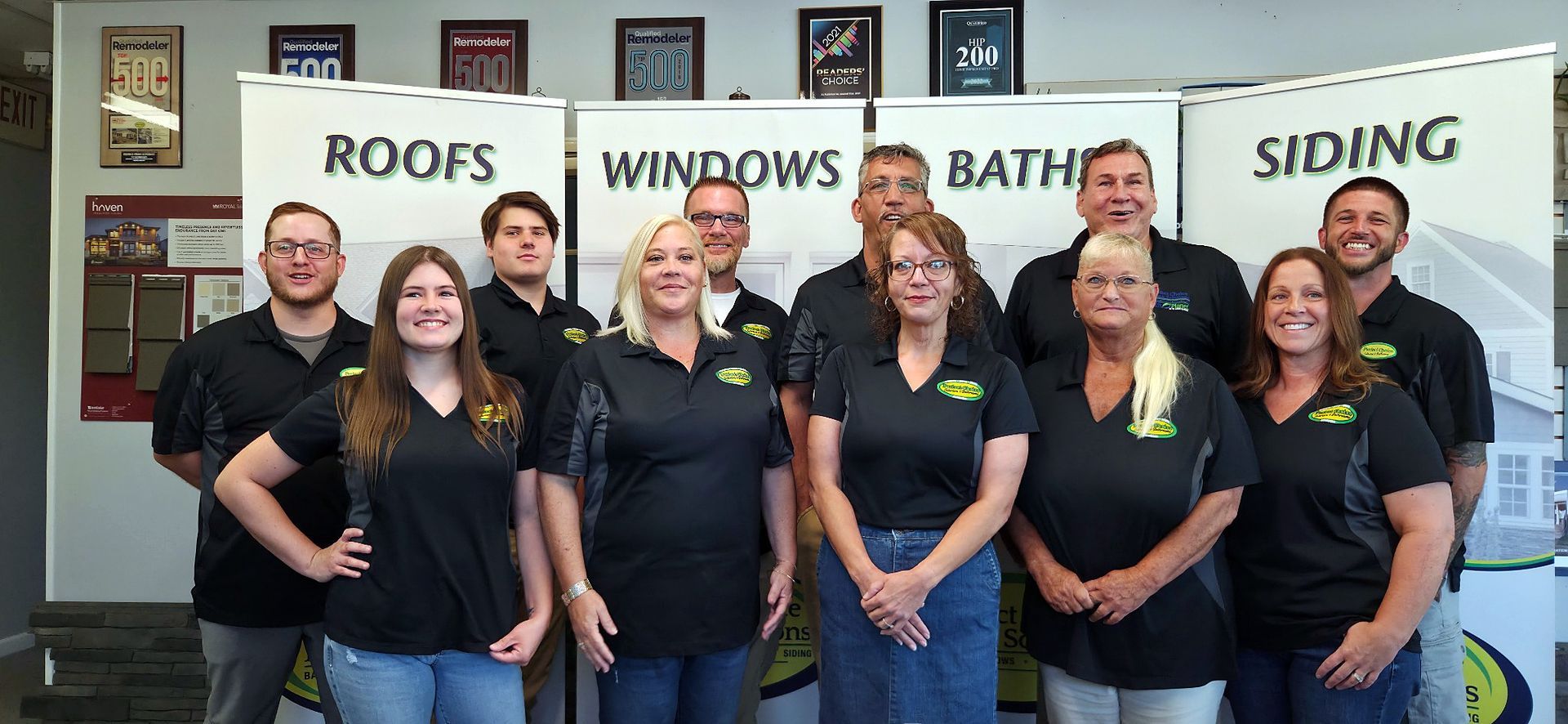 Group of people in black shirts standing in front of a sign for Perfect Choice Exteriors & Bathrooms.