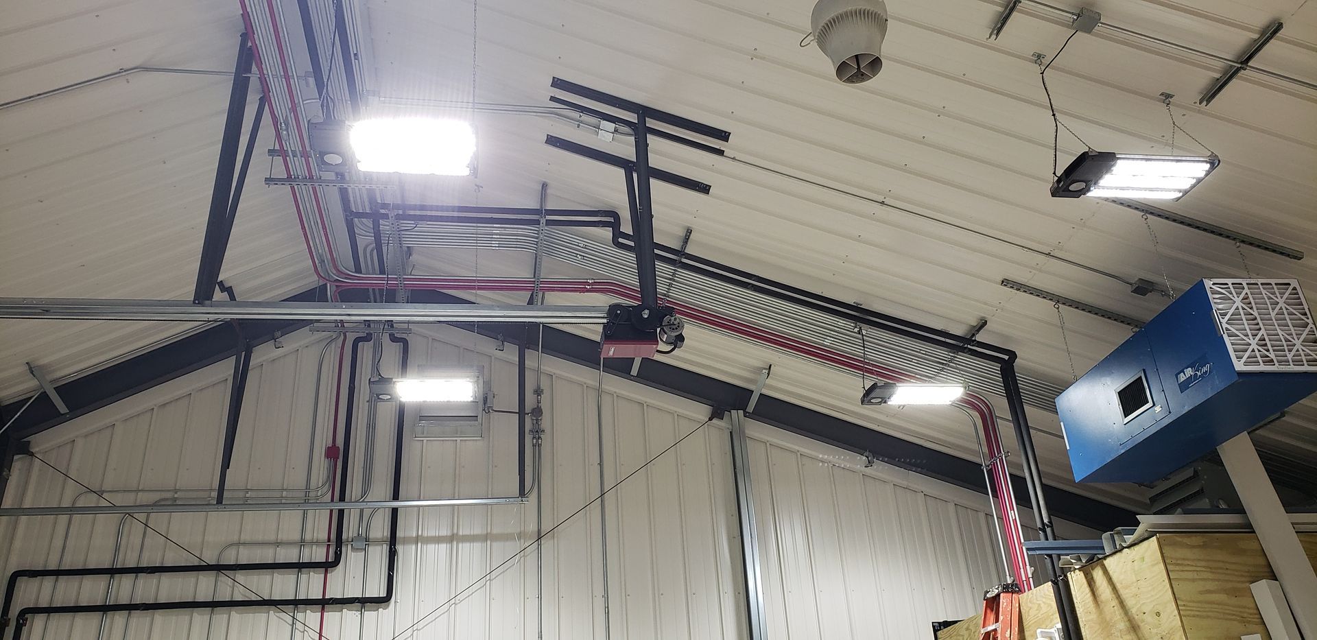 A basketball hoop is hanging from the ceiling of a building.