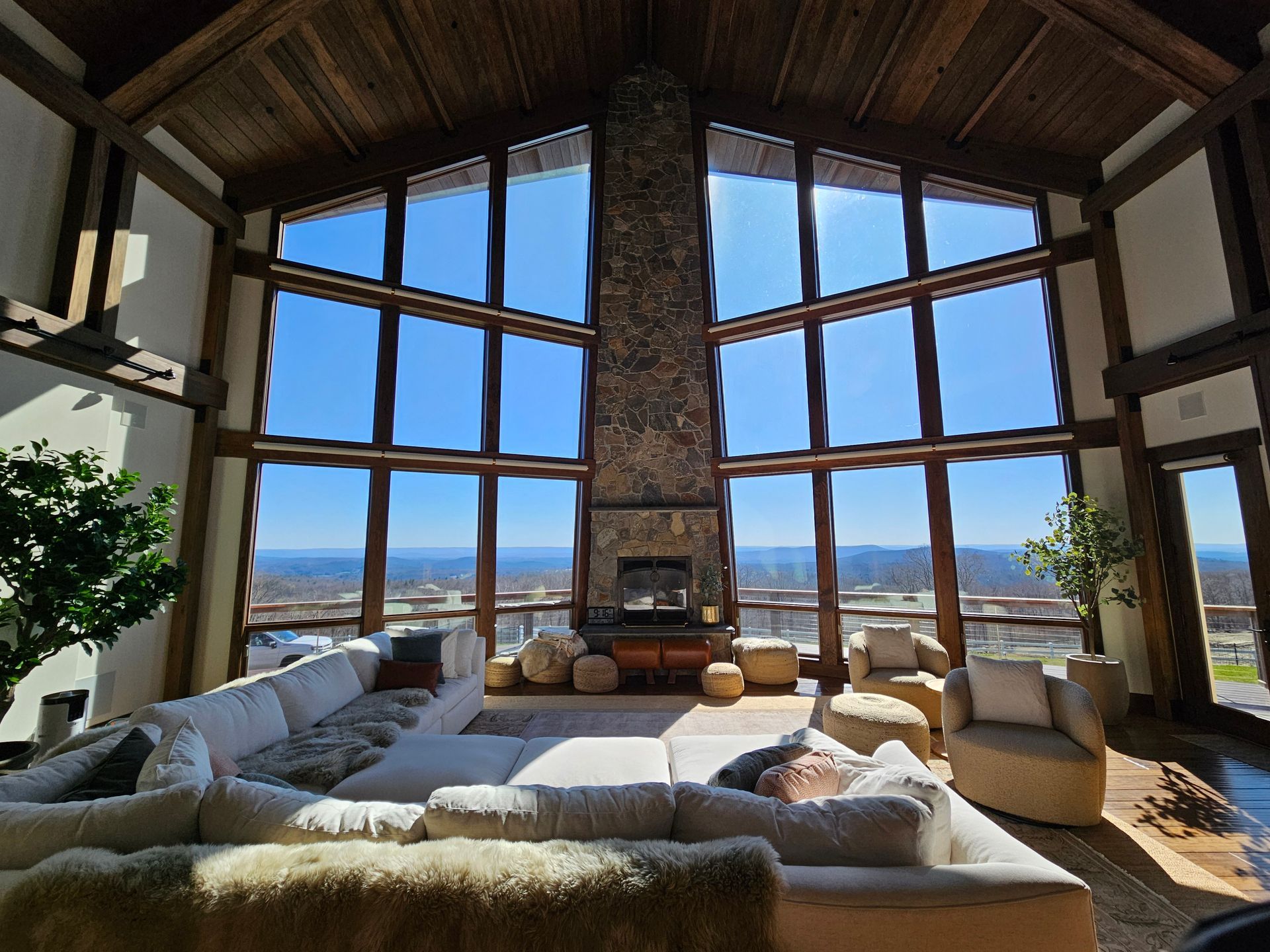 A living room with a lot of windows and a fireplace