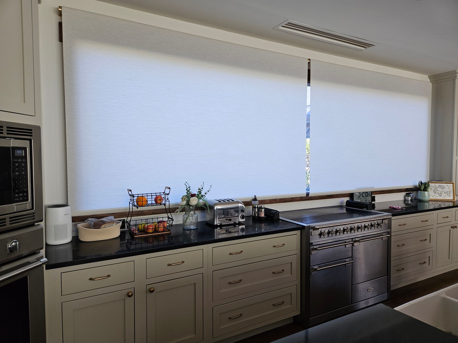 A kitchen with stainless steel appliances and white cabinets